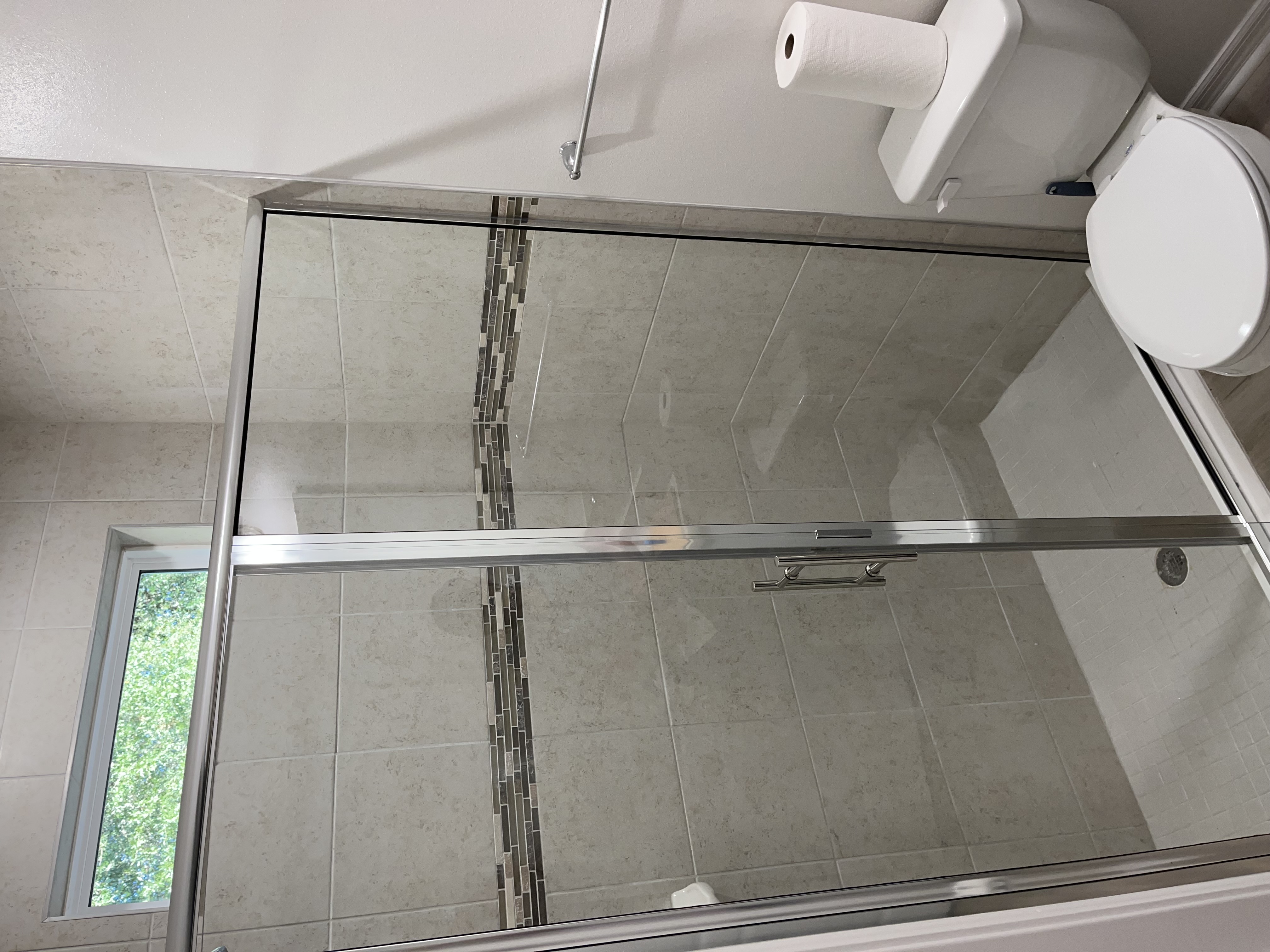Semi-frameless shower door with inline panel